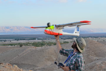 Chad Hill preparing to launch a fixed wing drone at Feifa, Jordan 2014 (Photo by Morag Kersel)