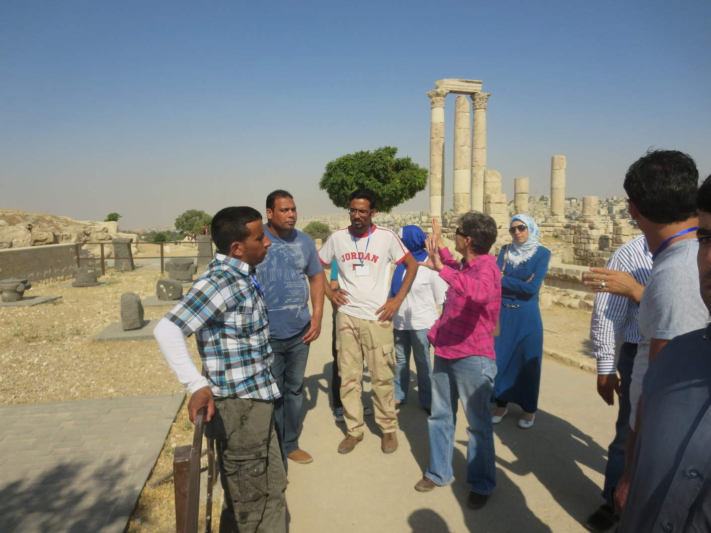 Shan Tsai (center, in pink shirt), former DOA site manager for Jabal Qala‘, leads the SCHEP site stewards on a tour of the Amman Citadel ruins. Photo by Abdelrahman al-Nasarat.