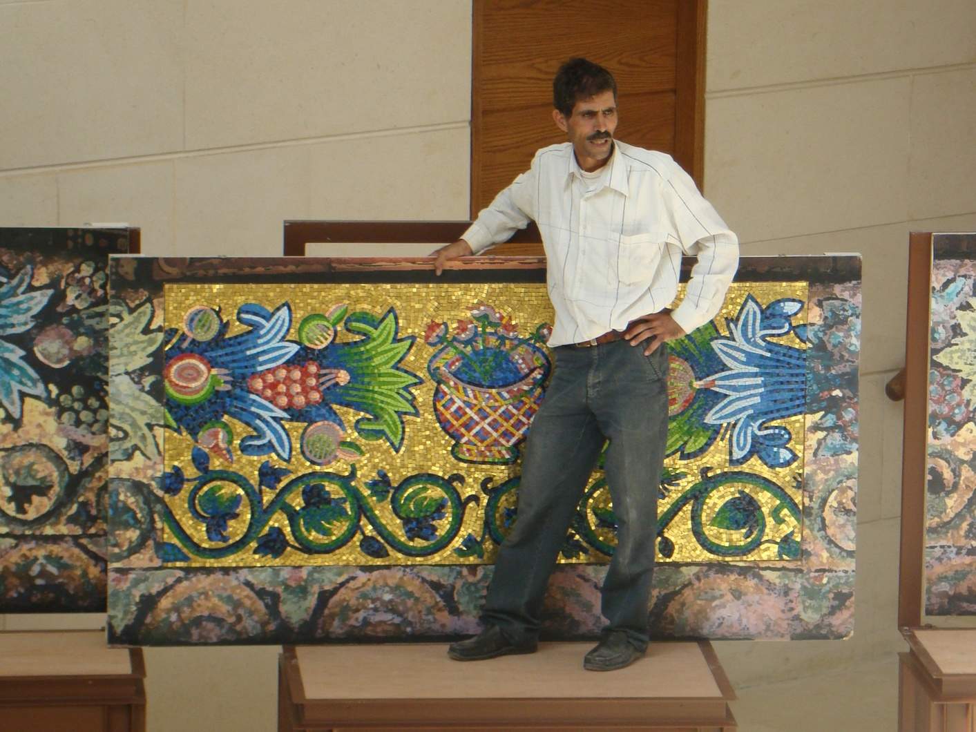 Naif Zaban at the Jordan Museum during the installation of the fall 2010 special exhibit The Umayyad Mosaics of the Dome of the Rock: A Closer Look, which included reproductions of an arcade spandrel created by the Mosaic Centre in Jericho. Photo by Barbara A. Porter.