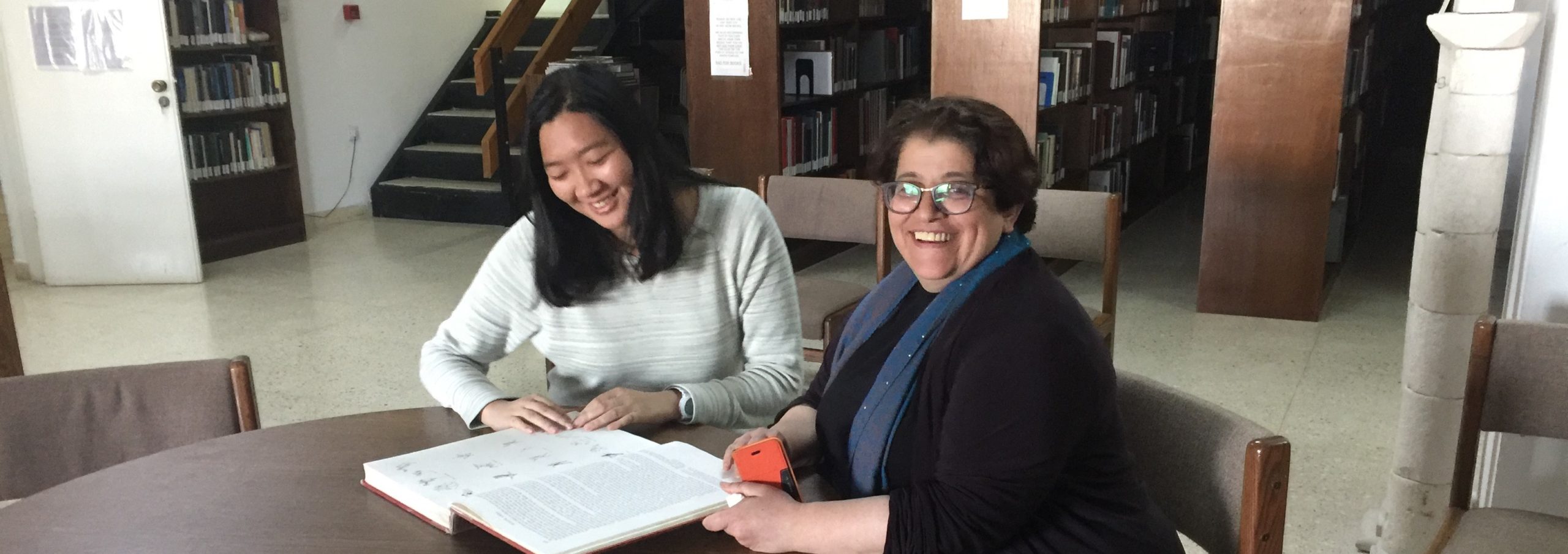 AMIDEAST student Ronnie Zhu (left) at work with NEH Fellow Dr. Aseel Sawalha in the ACOR Library (photo by S. Harpending)