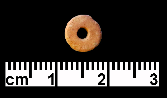 Red (limestone?) disc bead. (Photo by G. O. Rollefson.)