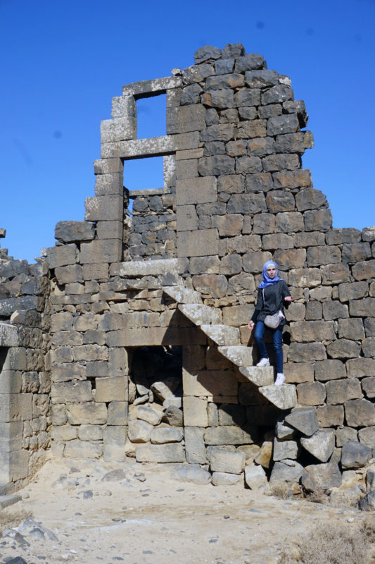 Samar Erman on stone steps at Umm al-Jimal